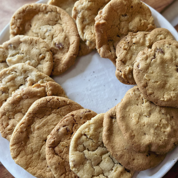 Freshly-baked-potato-chip-cookies-arranged-on-a-white-plate-These- cookies-are-golden-brown-with-visible-bits-of-crushed-potato-chips-and-pecans-They-have-a-crispy-texture-and-a-unique-flavor